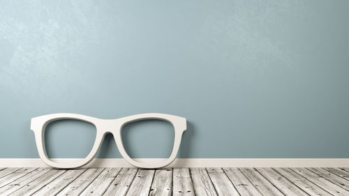 Close-up of empty blue table against wall