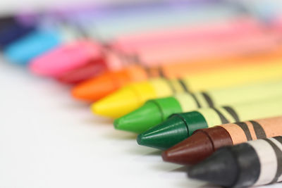 Close-up of colorful crayons on white background