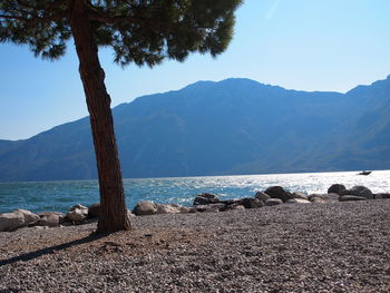 Scenic view of sea and mountains against sky