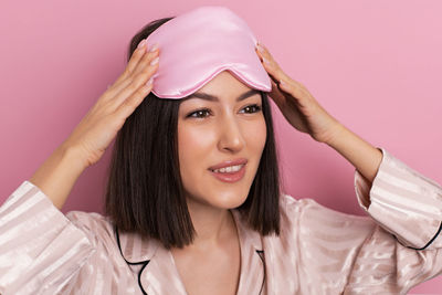 Portrait of young woman wearing hat