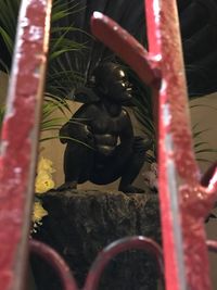 Close-up of statue by metal sculpture