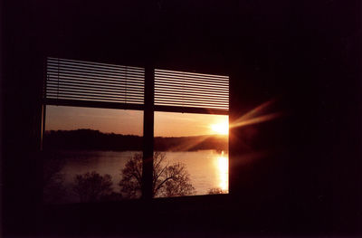 Scenic view of river against sky during sunset