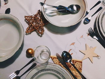 High angle view of crockery and christmas decorations on dinning table