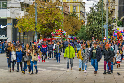 Group of people walking on street in city