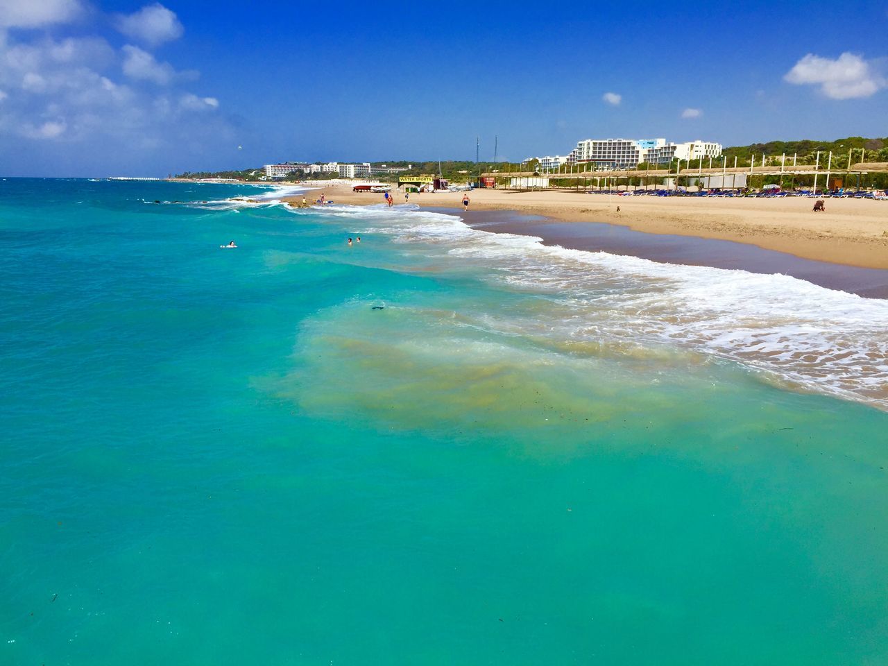 sea, water, beach, horizon over water, blue, sand, shore, sky, scenics, tranquil scene, beauty in nature, tranquility, wave, coastline, nature, surf, incidental people, turquoise colored, idyllic, vacations