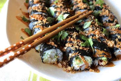 High angle view of sushi with chopsticks in plate