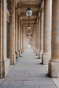 Corridor of historic buildings in royal gardens in paris, france.