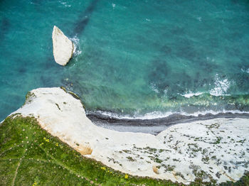 High angle view of cliff by sea