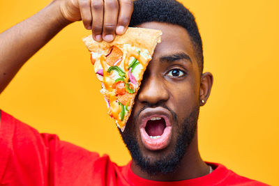 Close-up portrait of young man with food