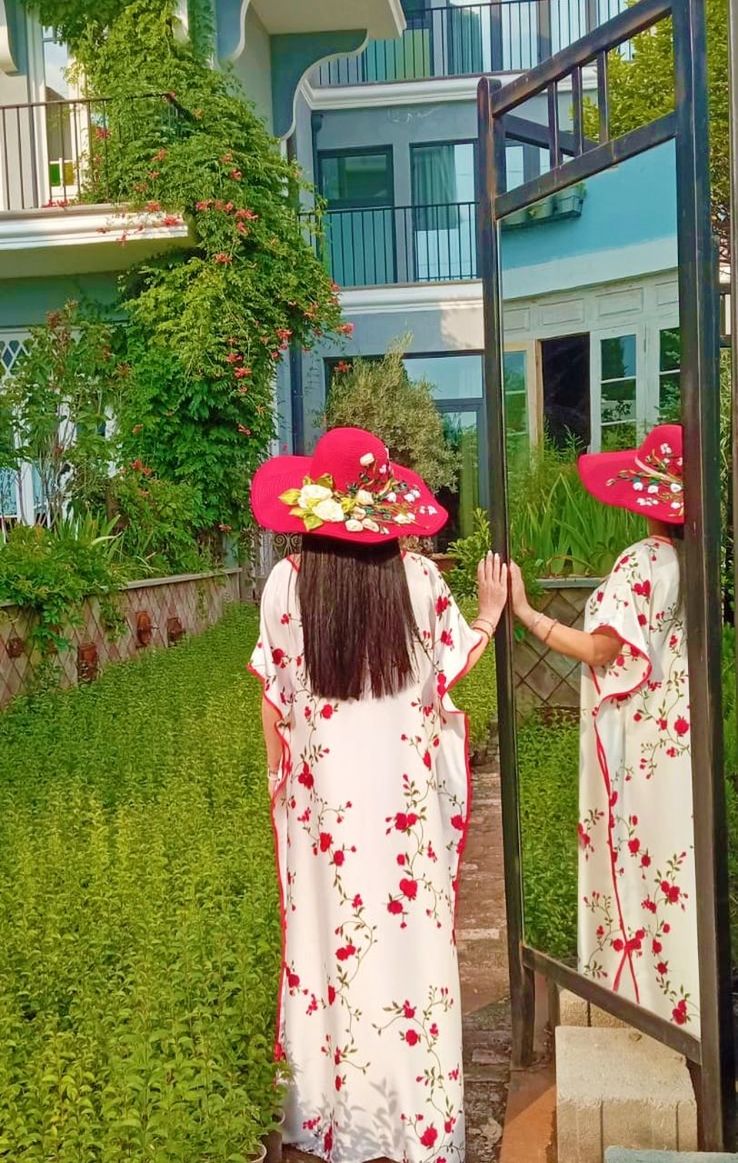 flower, building exterior, architecture, women, plant, built structure, clothing, one person, nature, female, day, dress, building, standing, childhood, adult, lifestyles, child, rear view, outdoors, celebration, flowering plant, house, front or back yard, full length, leisure activity, traditional clothing, residential district, tree, red, kimono, spring, tradition, hat, floral pattern