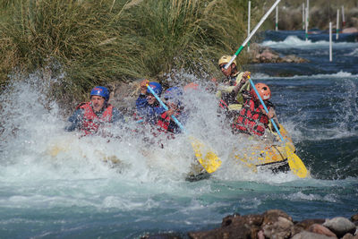 Rafting team struggling against the river