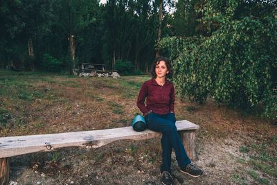 Portrait of smiling woman sitting on bench park