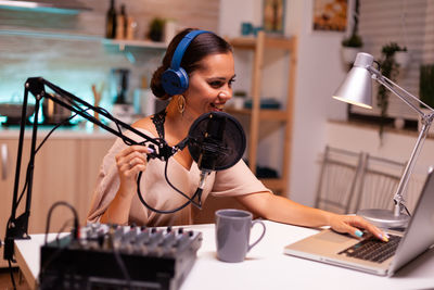 Young woman using laptop at table