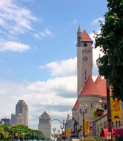 Clock tower in city against sky