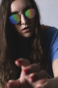 Close-up portrait of woman with vr glasses holding hands 