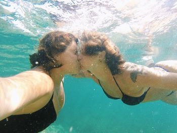 Couple kissing under the sea