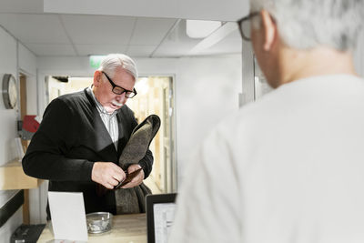 Senior man at reception in doctor's surgery