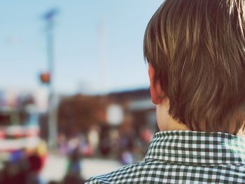 Rear view of boy against sky