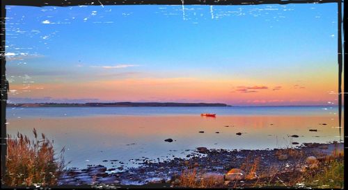 Scenic view of sea against sky at sunset