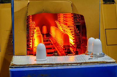 Front view of stove for making lampshades. close up of processed molten glass. light factory