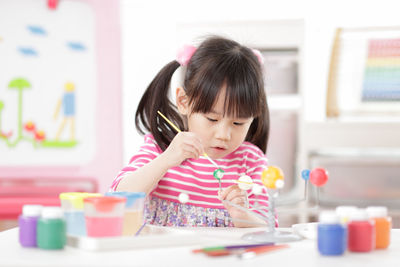 Young girl making craft for homeschooling