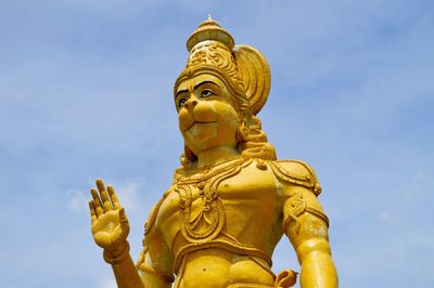 Low angle view of hanuman statue against blue sky
