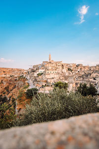 Wide view of the sassi di matera from the belvedere colombo blue sky with clouds, vertical