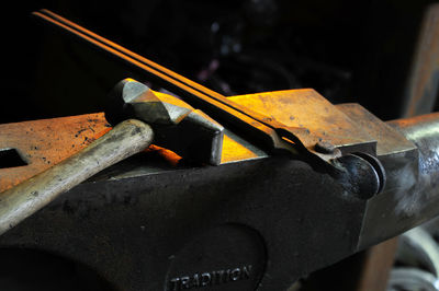 Tongs and hammer on anvil at workshop