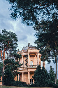 Low angle view of building against cloudy sky