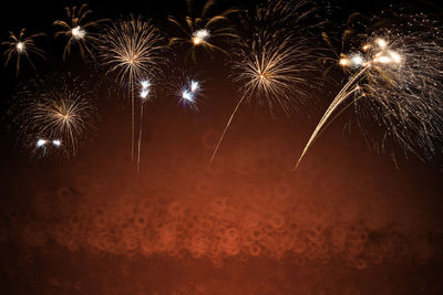 Low angle view of firework display at night