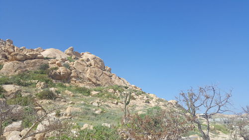 Low angle view of mountain against clear blue sky