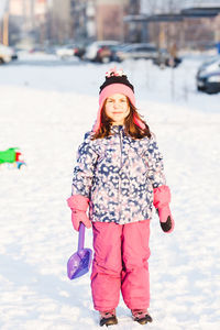 Full length of woman standing on snow