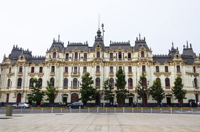 Facade of historic building against clear sky