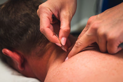 Side view of man massaging woman