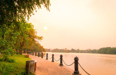 Scenic view of river against sky during sunset