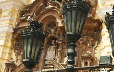 Low angle view of lighting equipment against saint francis monastery