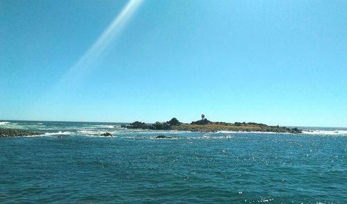 Scenic view of sea against blue sky