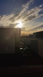 City street against sky during sunset