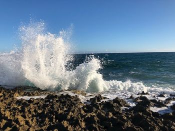 Sea waves splashing on rocks