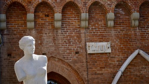 Low angle view of historic building with torso 