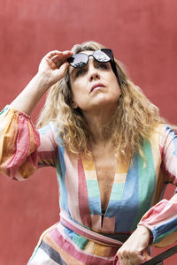 Blonde woman in sunglasses and striped dress