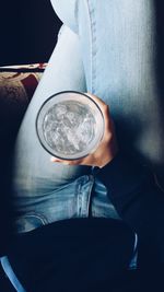 Low section of man holding coffee cup