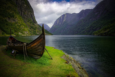 Scenic view of lake and mountains against sky