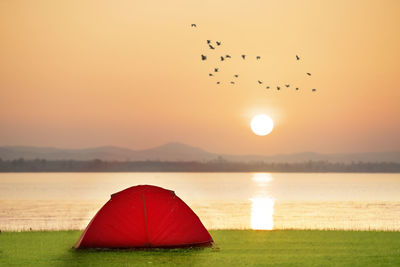 Scenic view of lake against sky during sunset