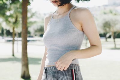 Midsection of woman standing in city