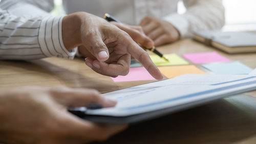 Midsection of businessman planning in office