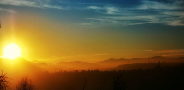 Scenic view of mountains against sky at sunset