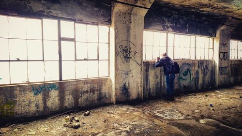 Man standing in corridor of building