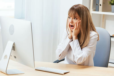 Young businesswoman using laptop at office