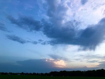 Scenic view of field against sky at sunset
